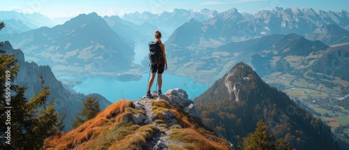 A person enjoying a scenic view from a mountain peak, symbolizing the achievement of long-term goals and the rewards of perseverance. The breathtaking landscape and the individual's triumphant pose photo