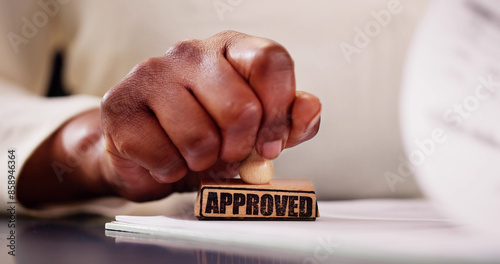 Notary Public with Afro-American hands approving a legal document in a black
