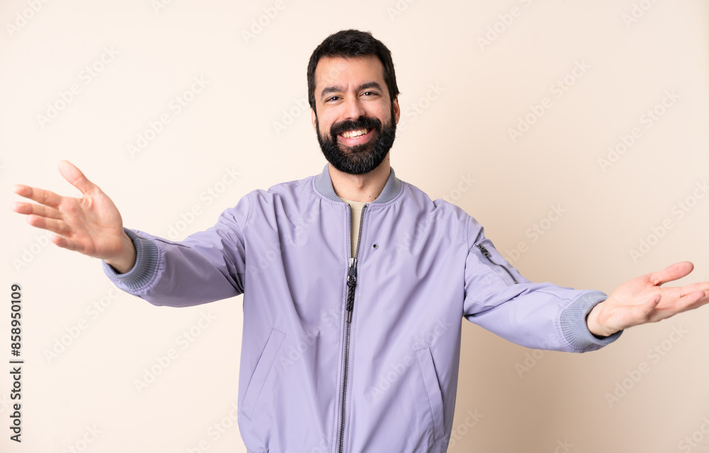Caucasian man with beard wearing a jacket over isolated background presenting and inviting to come with hand Caucasian man with beard wearing a jacket over isolated background presenting and inviting to come with hand