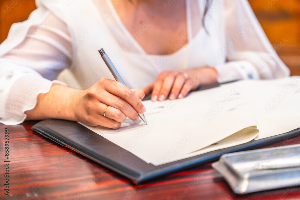 A woman is writing in a notebook A woman is writing in a notebook