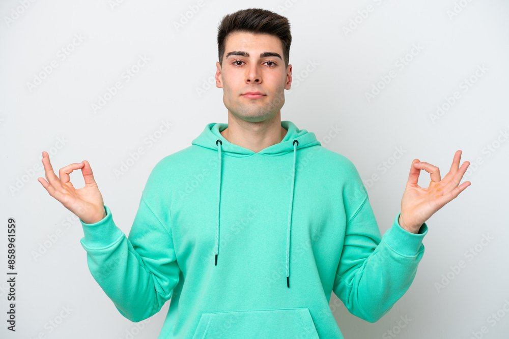 Young caucasian man isolated on white background in zen pose Young caucasian man isolated on white background in zen pose