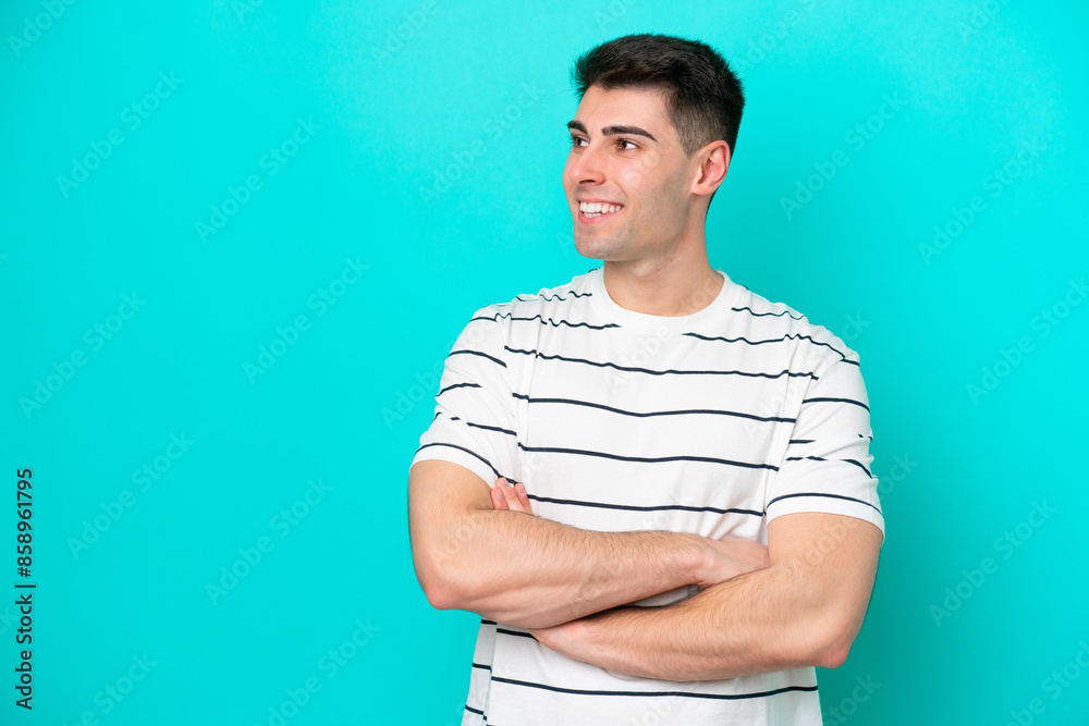 Young caucasian man isolated on blue background looking to the side Young caucasian man isolated on blue background looking to the side
