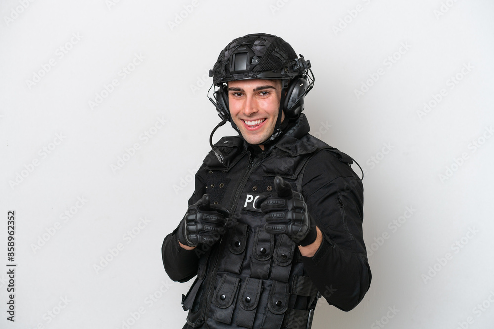 SWAT caucasian man isolated on white background pointing to the front and smiling SWAT caucasian man isolated on white background pointing to the front and smiling
