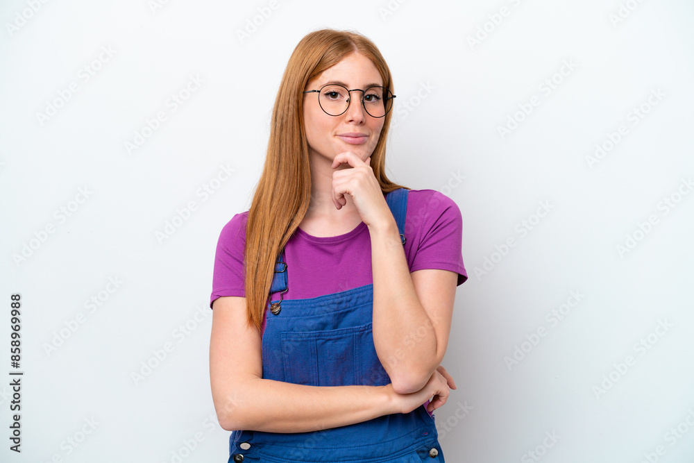 Young redhead woman isolated on white background thinking an idea while looking up Young redhead woman isolated on white background thinking an idea while looking up
