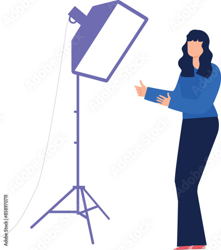 Girl standing under studio lights.