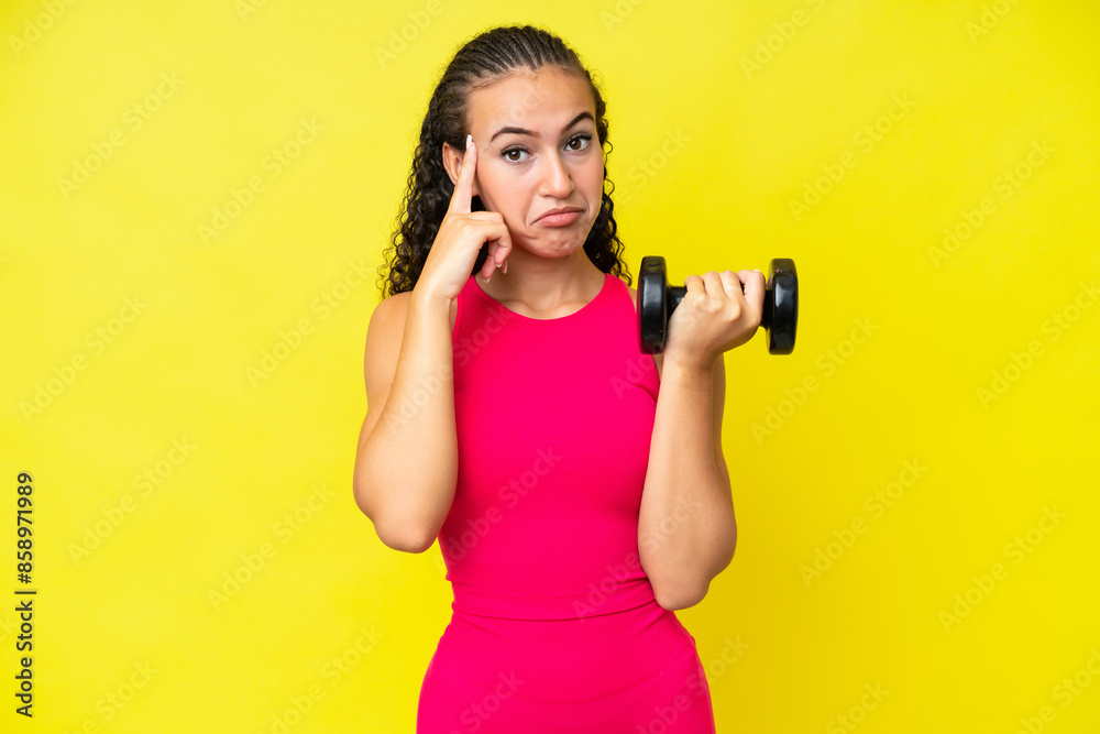Young sport woman making weightlifting isolated on yellow background thinking an idea Young sport woman making weightlifting isolated on yellow background thinking an idea