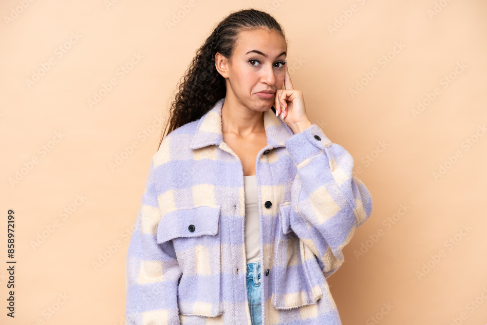 Young woman isolated on beige background thinking an idea Young woman isolated on beige background thinking an idea