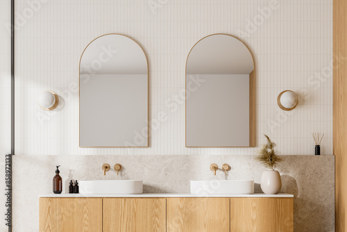 Konstfotografi Modern bathroom with wooden cabinets, dual sinks, and arched mirrors, light background