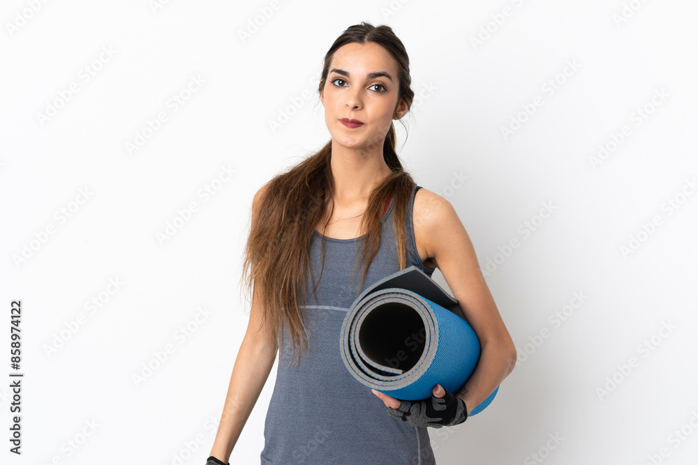 Young caucasian woman isolated on white background with a mat and smiling Young caucasian woman isolated on white background with a mat and smiling