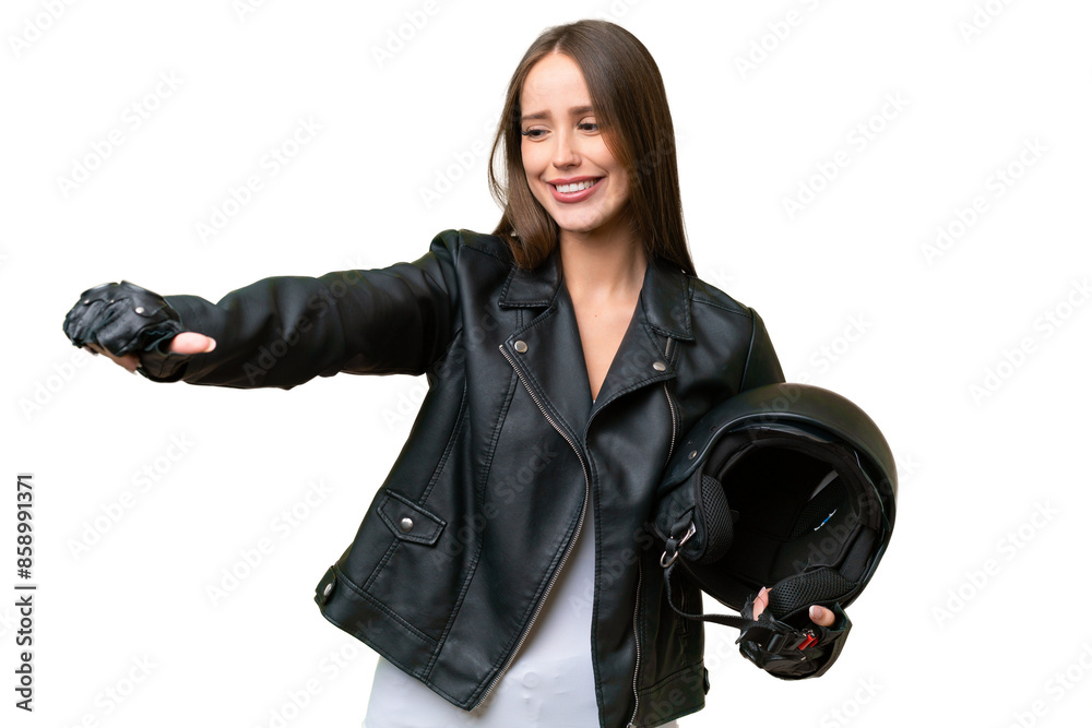 Young pretty caucasian woman with a motorcycle helmet over isolated background giving a thumbs up gesture Young pretty caucasian woman with a motorcycle helmet over isolated background giving a thumbs up gesture