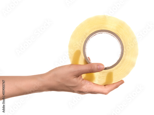 Female hand holding a large roll of transparent adhesive tape isolated on white background
