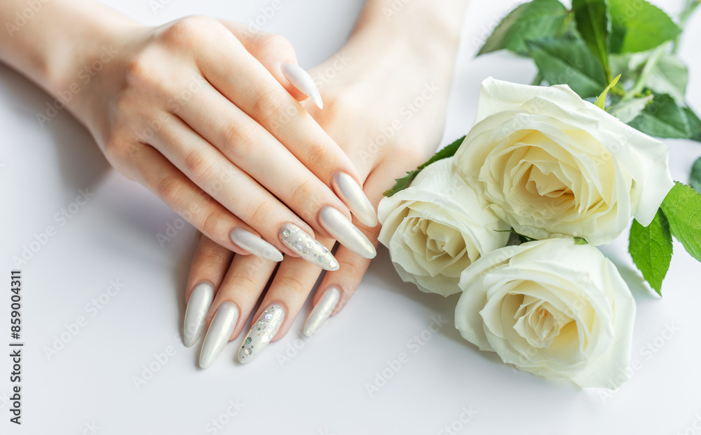 Female Hands on a white background with beautiful pearl manicure Female Hands on a white background with beautiful pearl manicure