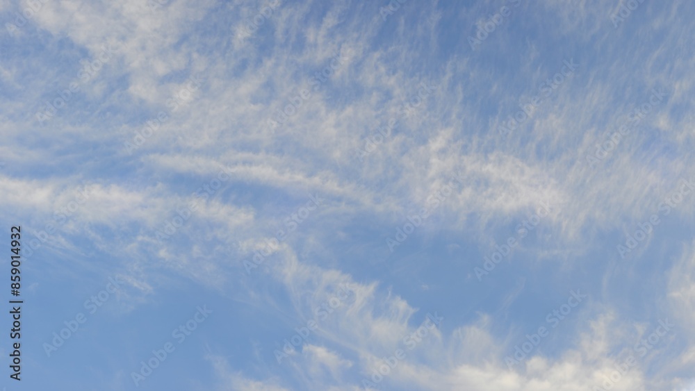 Clear blue sky with thin, wispy white clouds, resembling brush strokes across the sky. Clear blue sky with thin, wispy white clouds, resembling brush strokes across the sky.