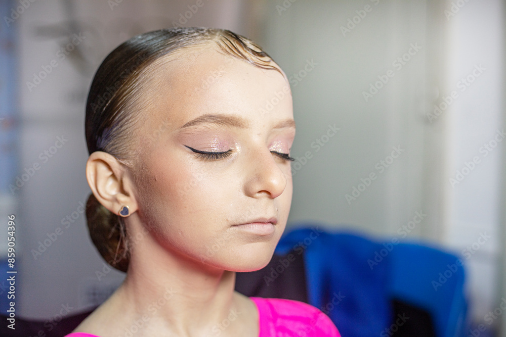 stylist applying eyeliner to a happy girl's eyelids before a ballroom dancing tournament. Fashion & Style stylist applying eyeliner to a happy girl's eyelids before a ballroom dancing tournament. Fashion & Style
