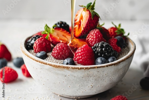 Bowl of Chia Pudding Topped with Fresh Berries and Honey