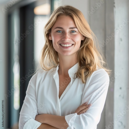 Happy, business leader and woman with a smile in success with crossed arms in a light office. Portrait of a professional and confident white female employee in leadership and management at a company