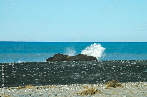 Strolling on the beach under the winter sun in New Zealand