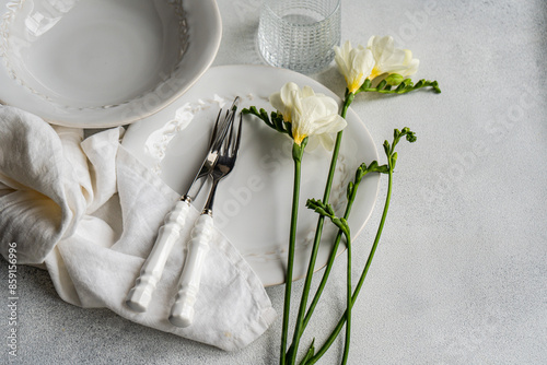 Elegant Freesia-themed table setting with white and silver accents