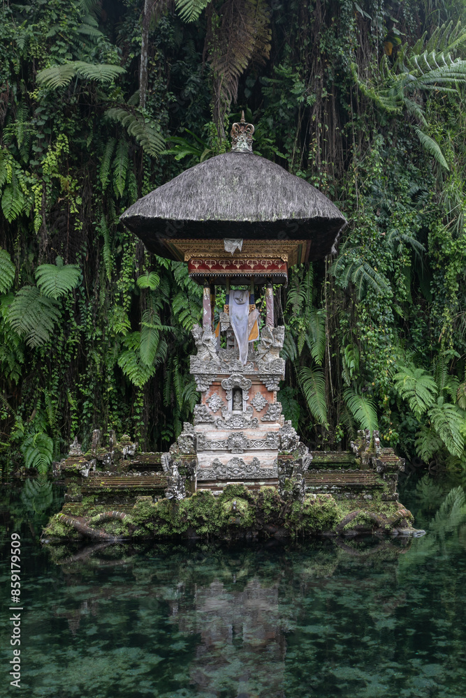 Balinese religious sanctuary of Pura Gunung Kawi Sebatu surrounded by green mystical waters. Dense deep jungle looms all around. Balinese religious sanctuary of Pura Gunung Kawi Sebatu surrounded by green mystical waters. Dense deep jungle looms all around.