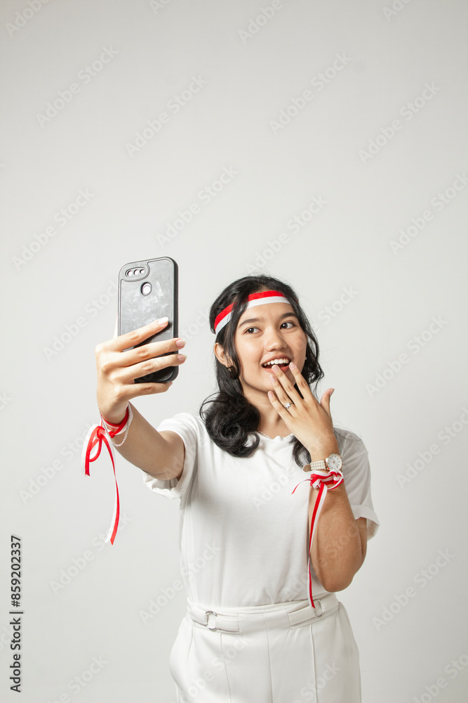 a beautiful young woman taking a selfie with her hand holding her mouth isolated on a white background, indonesian woman a beautiful young woman taking a selfie with her hand holding her mouth isolated on a white background, indonesian woman