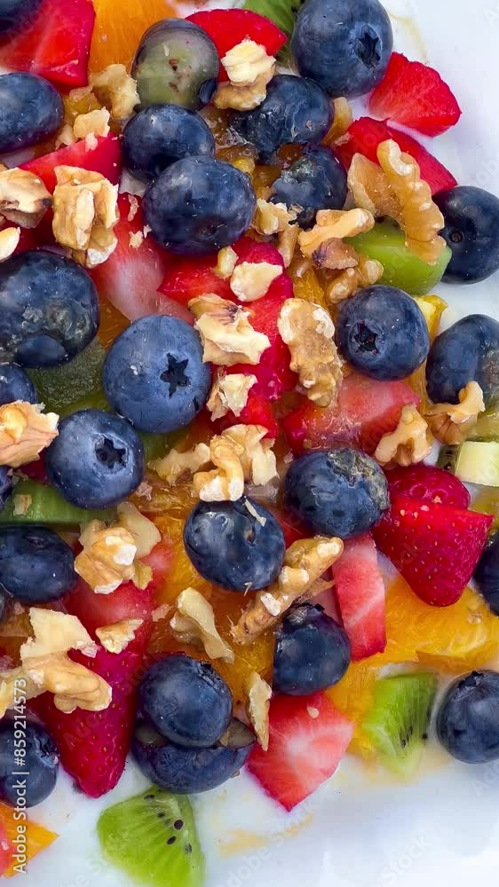 Healthy breakfast fresh fruits blueberries, raspberries, kiwis, tangerines, strawberries and nuts with yogurt. Healthy lifestyle. High quality 4k footage Healthy breakfast fresh fruits blueberries, raspberries, kiwis, tangerines, strawberries and nuts with yogurt. Healthy lifestyle. High quality 4k footage