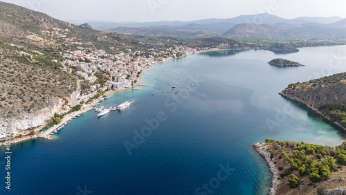 Aerial drone photo of famous seaside village small port and long sandy beach of Tolo with hotels and resorts built by the sea, Argolida, Peloponnese, Greece