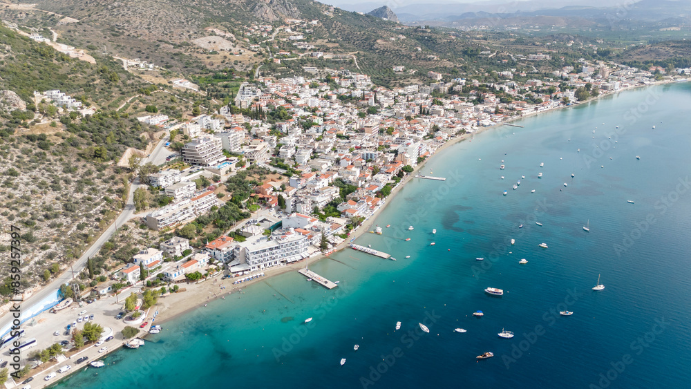Aerial drone photo of famous seaside village small port and long sandy beach of Tolo with hotels and resorts built by the sea, Argolida, Peloponnese, Greece Aerial drone photo of famous seaside village small port and long sandy beach of Tolo with hotels and resorts built by the sea, Argolida, Peloponnese, Greece
