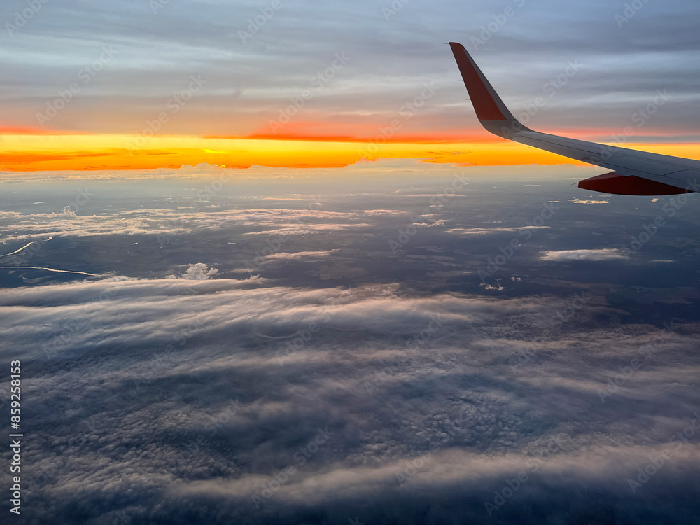 Spectacular Sunset View from Airplane Window During Flight Above Clouds. Spectacular Sunset View from Airplane Window During Flight Above Clouds.