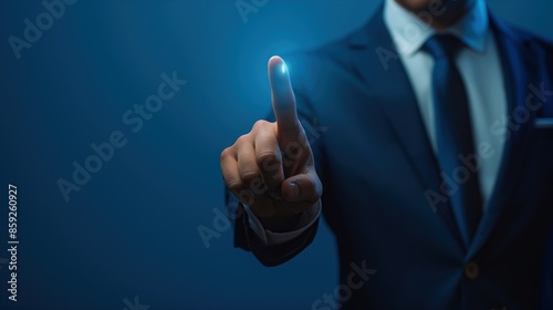 Businessman in suit touching screen with finger on blue background