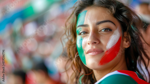 A female fan at the stadium, the national flag of Italy is painted on her face. photo