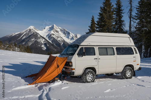 Cozy wintercamping with a camper van. Camping in the snow. Caravan and RV on a camp site photo