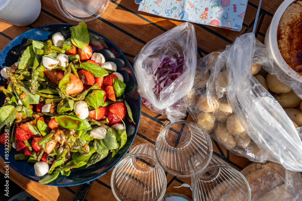 Φωτογραφία Stockholm, Sweden A picnic on a small motorboat consisting of boiled potatoes,
