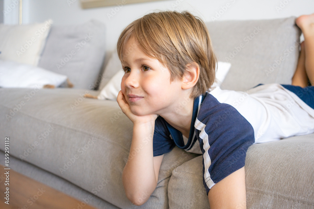 Close up profil of cute little 5 years old boy looking tv at home Close up profil of cute little 5 years old boy looking tv at home