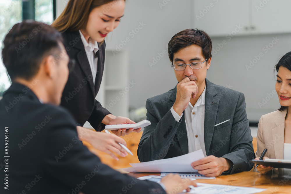 Diverse business team analyzing data and discussing strategies during an office meeting, using documents and a laptop. Diverse business team analyzing data and discussing strategies during an office meeting, using documents and a laptop.