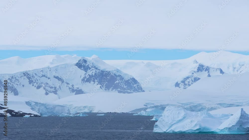Antarctica Land of Snow and Ice Huge Iceberg Passes By Glacier Snow Covered Mountains. Incredible Scenery Antarctica Land of Snow and Ice Huge Iceberg Passes By Glacier Snow Covered Mountains. Incredible Scenery