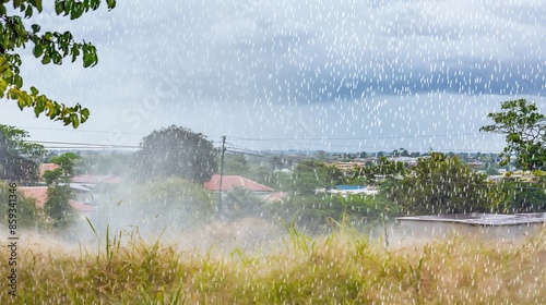 Green rural landscape with trees and houses under a gentle rainfall, showcasing the beauty and serenity of nature.