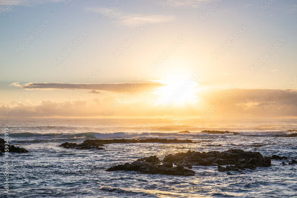 Sunrise over the sea with light waves. Sand beach with lava rocks and blue water alternate with blue water. Island in the Indian Ocean, beach out of the blue, Trou d’Eau Douce, Mauritius, Africa Sunrise over the sea with light waves. Sand beach with lava rocks and blue water alternate with blue water. Island in the Indian Ocean, beach out of the blue, Trou d’Eau Douce, Mauritius, Africa