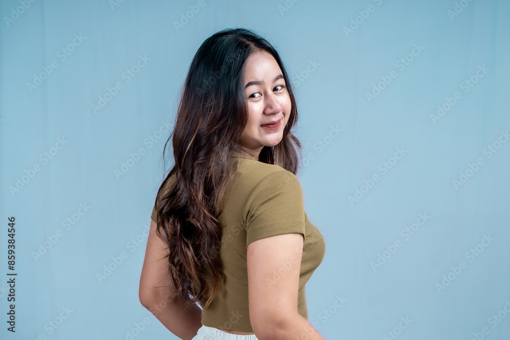 Photo of active Asian girl isolated blue color background Photo of active Asian girl isolated blue color background
