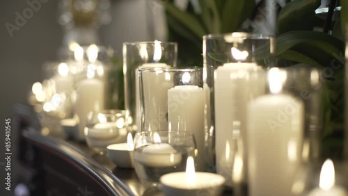 many white lit candles in a wedding decoration