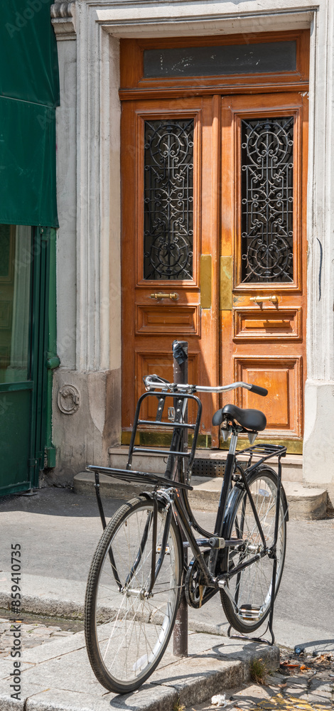Old bicycle parked by a wooden door in Paris Old bicycle parked by a wooden door in Paris