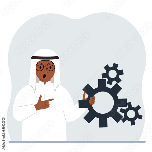 A man holds gears in his hand. Points a finger at the cogwheels. The concept of financial planning, movement, life, education or maintenance.