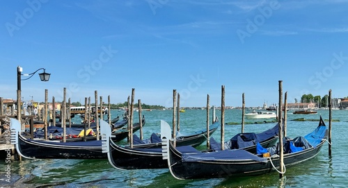 Obraz na płótnie Beautiful blue gondolas parked at dock in Venice, Italy w salonie