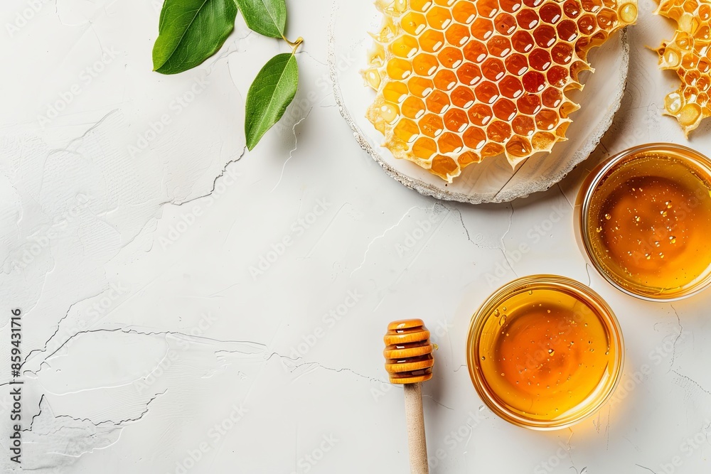 Honey with honeycomb and wooden spoon on white, copy space Honey with honeycomb and wooden spoon on white, copy space