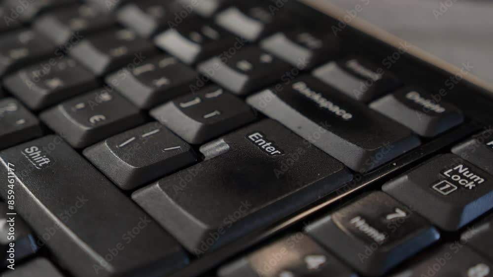 close up black computer keyboard. enter key. finger press enter. continue working hard in office or company close up black computer keyboard. enter key. finger press enter. continue working hard in office or company