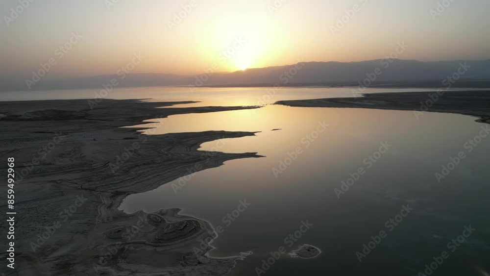 Aerial video over sinkholes in the Dead Sea Israel at sunrise