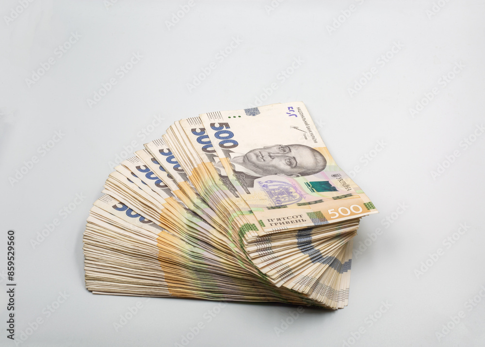 Ukrainian hryvna currency notes heap closeup on white.