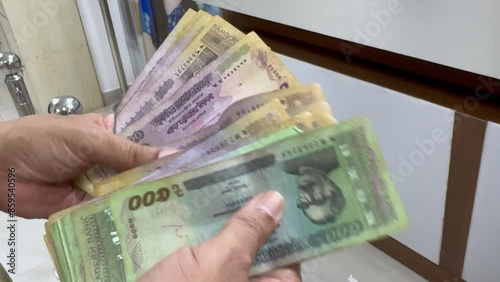 Bangladeshi Man counting Bangladeshi Currency Note Taka. BDT currency of Bangladesh.  photo