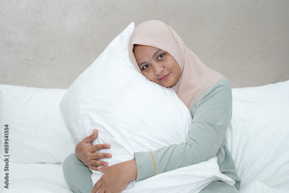 Portrait of an Asian woman wearing a hijab in the bedroom Portrait of an Asian woman wearing a hijab in the bedroom