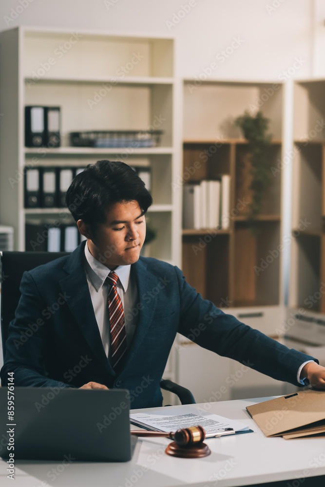 Male lawyer working with contract papers and wooden gavel on tabel in courtroom. justice and law ,attorney, court judge, concept. Male lawyer working with contract papers and wooden gavel on tabel in courtroom. justice and law ,attorney, court judge, concept.