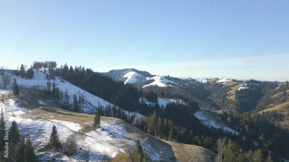 Drone footage of the snow melting on the mountain forests in the early spring, Switzerland